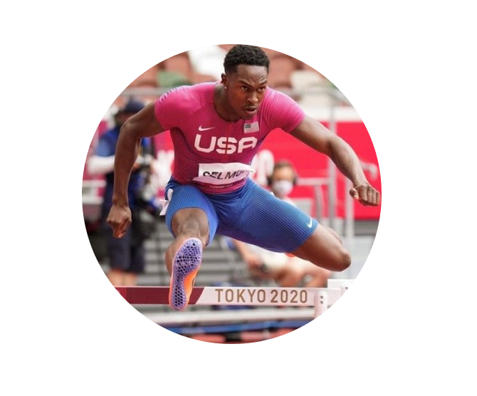 A man in pink shirt jumping over a hurdle.